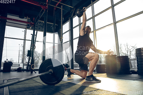 Image of The male athlete training hard in the gym. Fitness and healthy life concept.