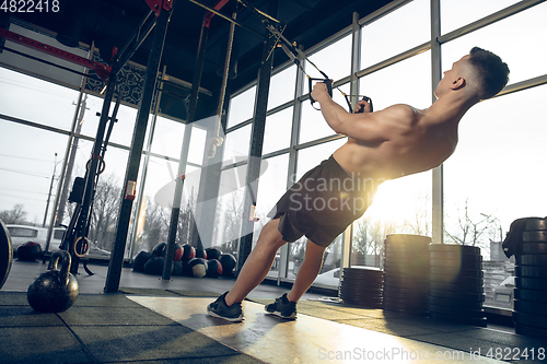 Image of The male athlete training hard in the gym. Fitness and healthy life concept.