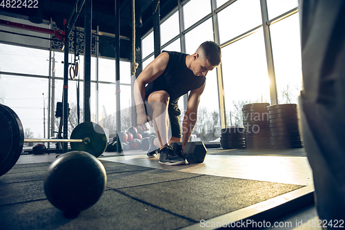 Image of The male athlete training hard in the gym. Fitness and healthy life concept.