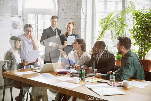 Image of Group of young business professionals having a meeting, creative office