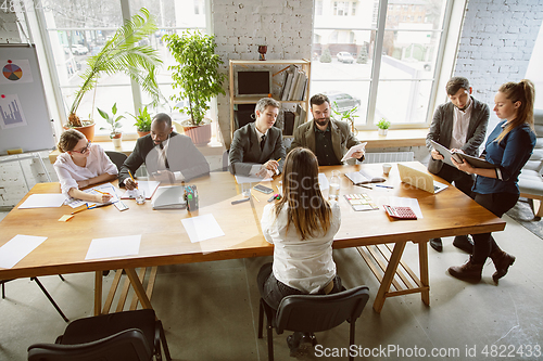 Image of Group of young business professionals having a meeting, creative office