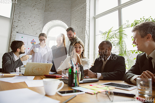Image of Group of young business professionals having a meeting, creative office