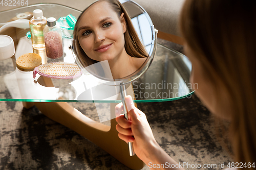 Image of Beauty Day. Woman doing her daily skincare routine at home