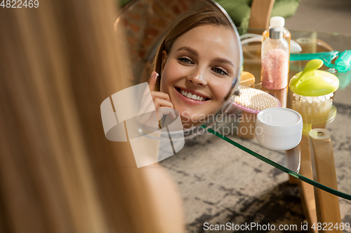 Image of Beauty Day. Woman doing her daily skincare routine at home