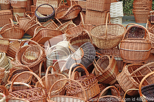 Image of Bunch of various empty wicker wooden baskets