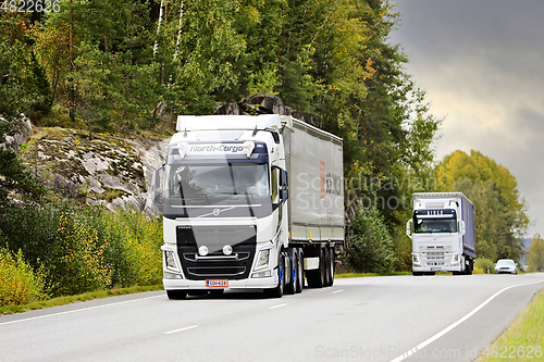 Image of Two White Volvo Semi Trailer Trucks on Road