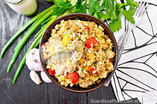 Image of Barley porridge with minced meat in bowl on board top