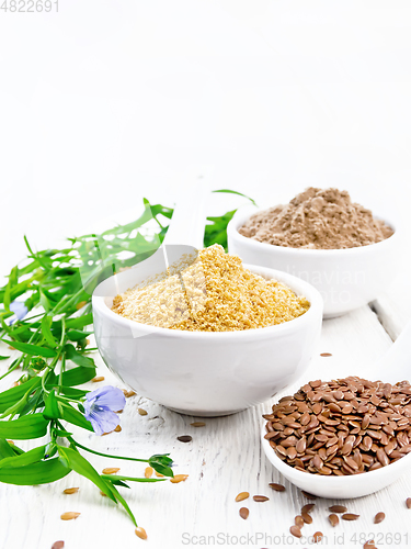 Image of Bran and flour flaxseed in bowls on white wooden board