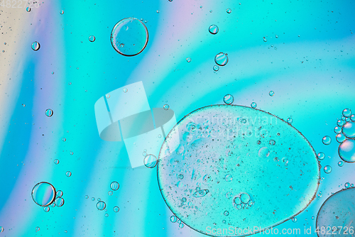 Image of Holographic colorful abstract background with oil drops on water