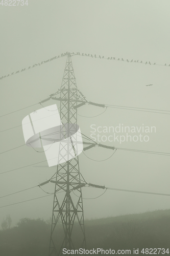 Image of high voltage electric pillar in fog