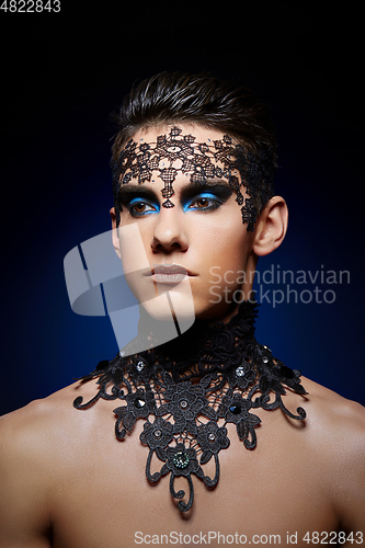 Image of young man wiht dark makeup