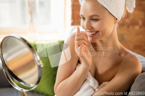 Image of Beauty Day. Woman doing her daily skincare routine at home