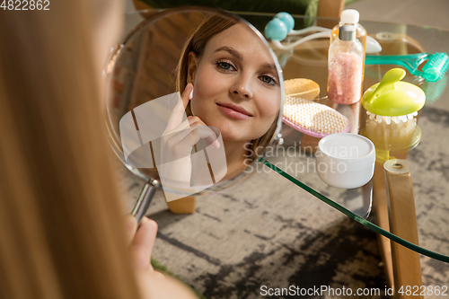 Image of Beauty Day. Woman doing her daily skincare routine at home