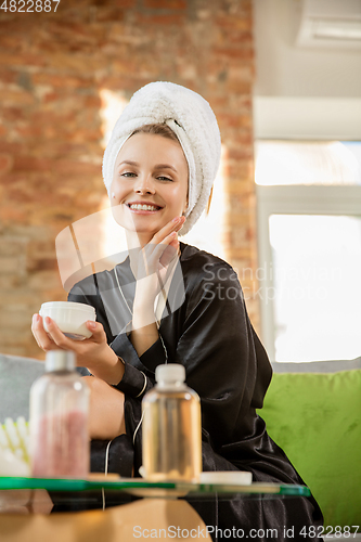 Image of Beauty Day. Woman doing her daily skincare routine at home