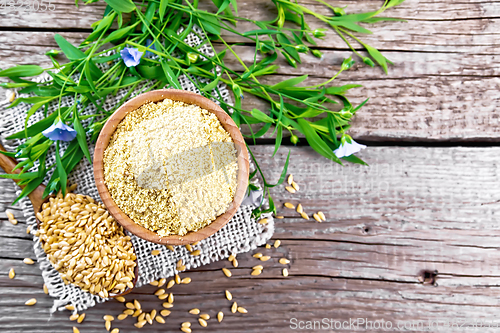 Image of Bran flaxseed in bowl on old board top