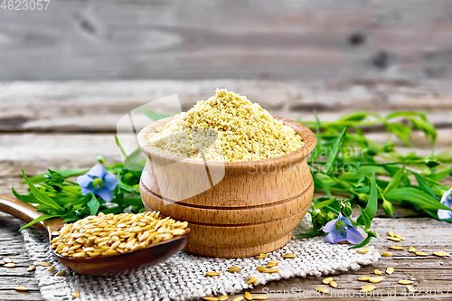 Image of Bran flaxseed in bowl on wooden board