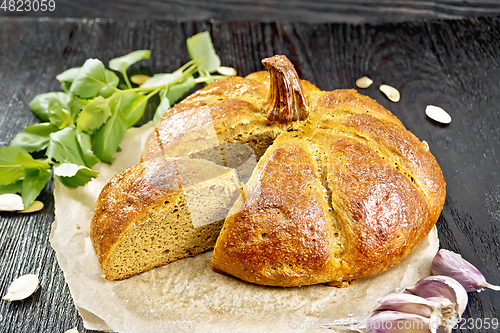 Image of Bread pumpkin cut on a black board