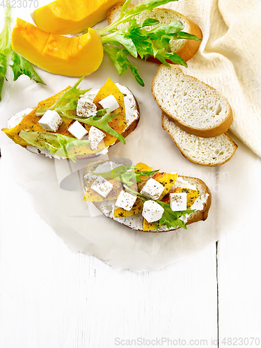 Image of Bruschetta with pumpkin and ricotta on board top