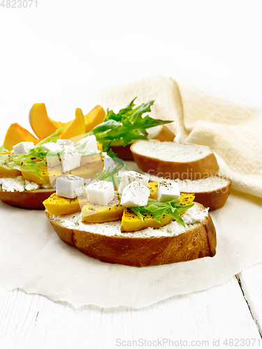 Image of Bruschetta with pumpkin and ricotta on light board