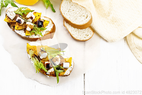 Image of Bruschetta with pumpkin and sauce on board top
