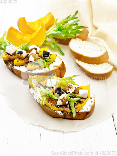 Image of Bruschetta with pumpkin and sauce on light board