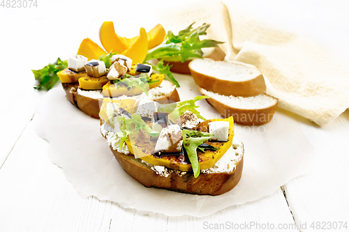 Image of Bruschetta with pumpkin and sauce on white board