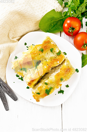 Image of Cannelloni with curd and spinach in plate on board top