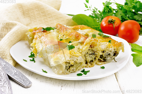 Image of Cannelloni with curd and spinach in plate on board