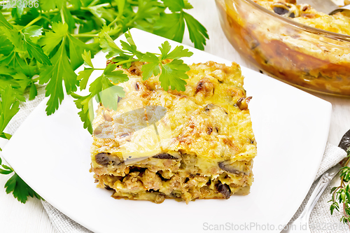 Image of Casserole of meat and eggplant in plate on white board