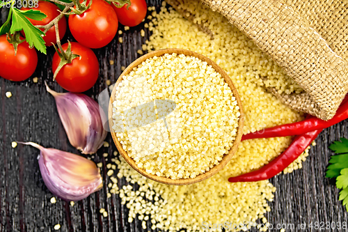 Image of Couscous raw in bowl on board top