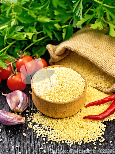 Image of Couscous raw in bowl on board