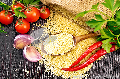 Image of Couscous raw in spoon on board top