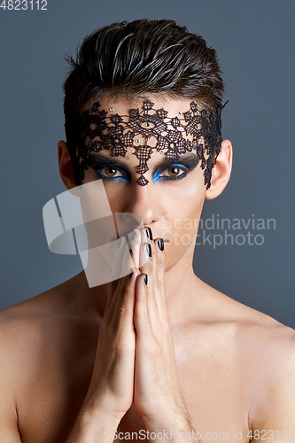 Image of young man wiht dark makeup