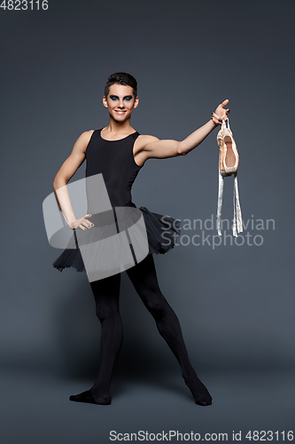 Image of handsome ballet artist in tutu skirt