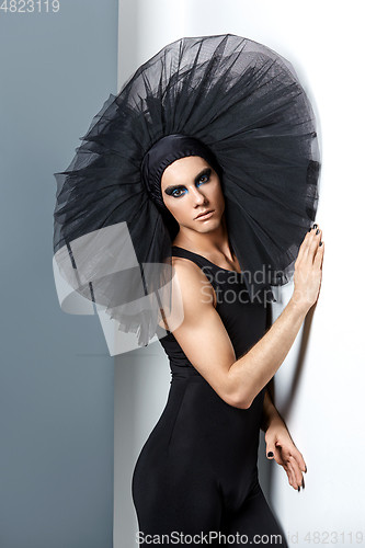 Image of handsome ballet artist in tutu skirt