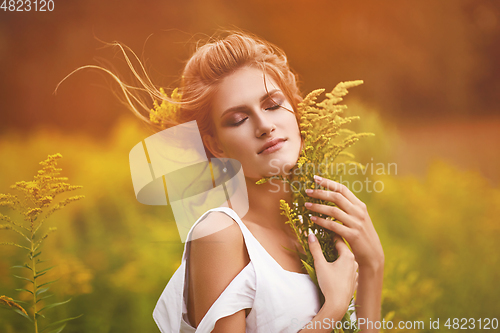 Image of beautiful girl in field