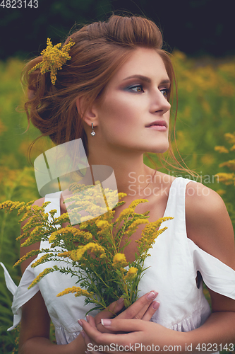 Image of beautiful girl in field