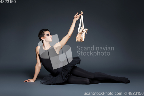 Image of handsome ballet artist in tutu skirt