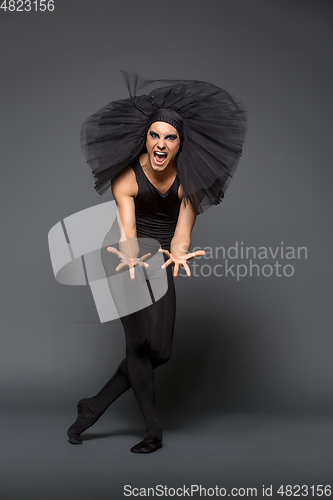 Image of handsome ballet artist in tutu skirt