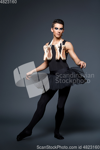 Image of handsome ballet artist in tutu skirt