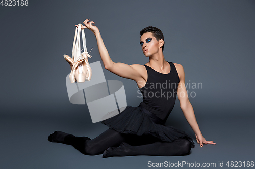 Image of handsome ballet artist in tutu skirt