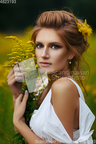 Image of beautiful girl in field