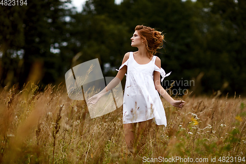 Image of beautiful girl in field