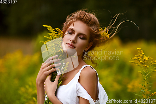 Image of beautiful girl in field
