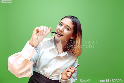 Image of Little girl dreaming about future profession of makeup and hairstyle artist