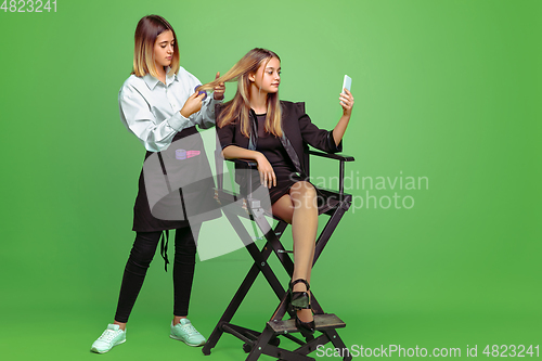 Image of Little girl dreaming about future profession of visage and hairstyle artist