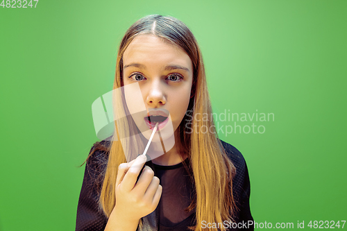 Image of Little girl dreaming about future profession of makeup and hairstyle artist