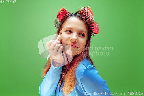 Image of Little girl dreaming about future profession of makeup and hairstyle artist