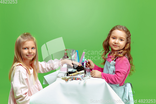 Image of Little girl dreaming about future profession of nails manicure artist