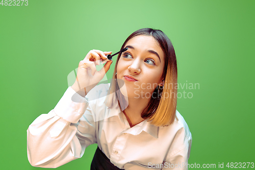 Image of Little girl dreaming about future profession of makeup and hairstyle artist